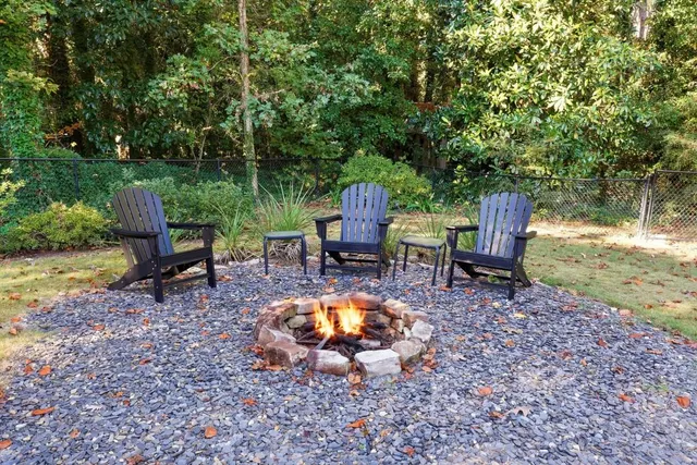 a view of a chairs and table in backyard