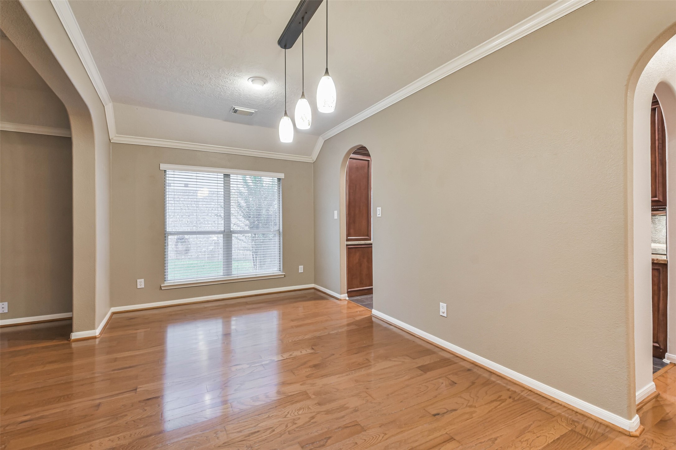 20942 Wind Field Lane Spring, TX 77379 - Photo 7 of 46 a view of an empty room with wooden floor and a window