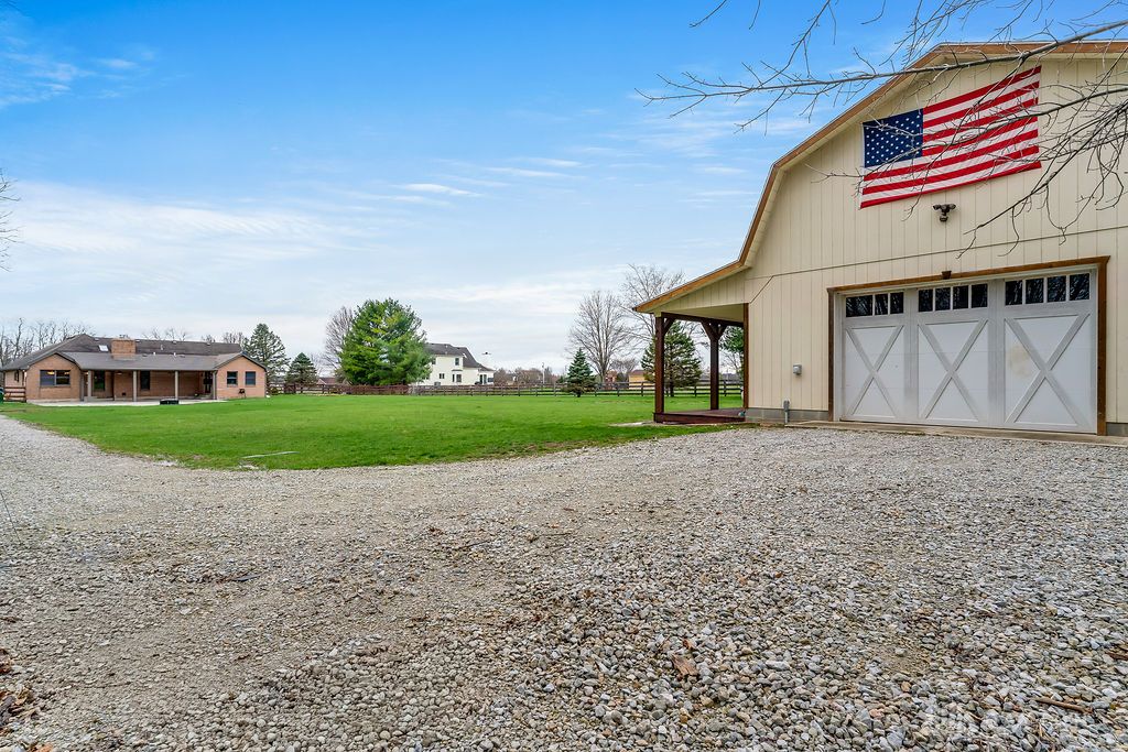 7400 Cook-Jones Road Waynesville, OH 45068 - Photo 59 of 72 This expansive estate features a barn with a spacious gravel driveway, offering ample parking and outdoor space.