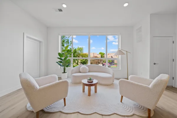 a living room with furniture and a potted plant