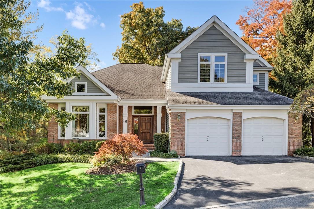 10 Longledge Drive Rye Brook, NY 10573 - Photo 1 of 1 a front view of a house with a yard and garage