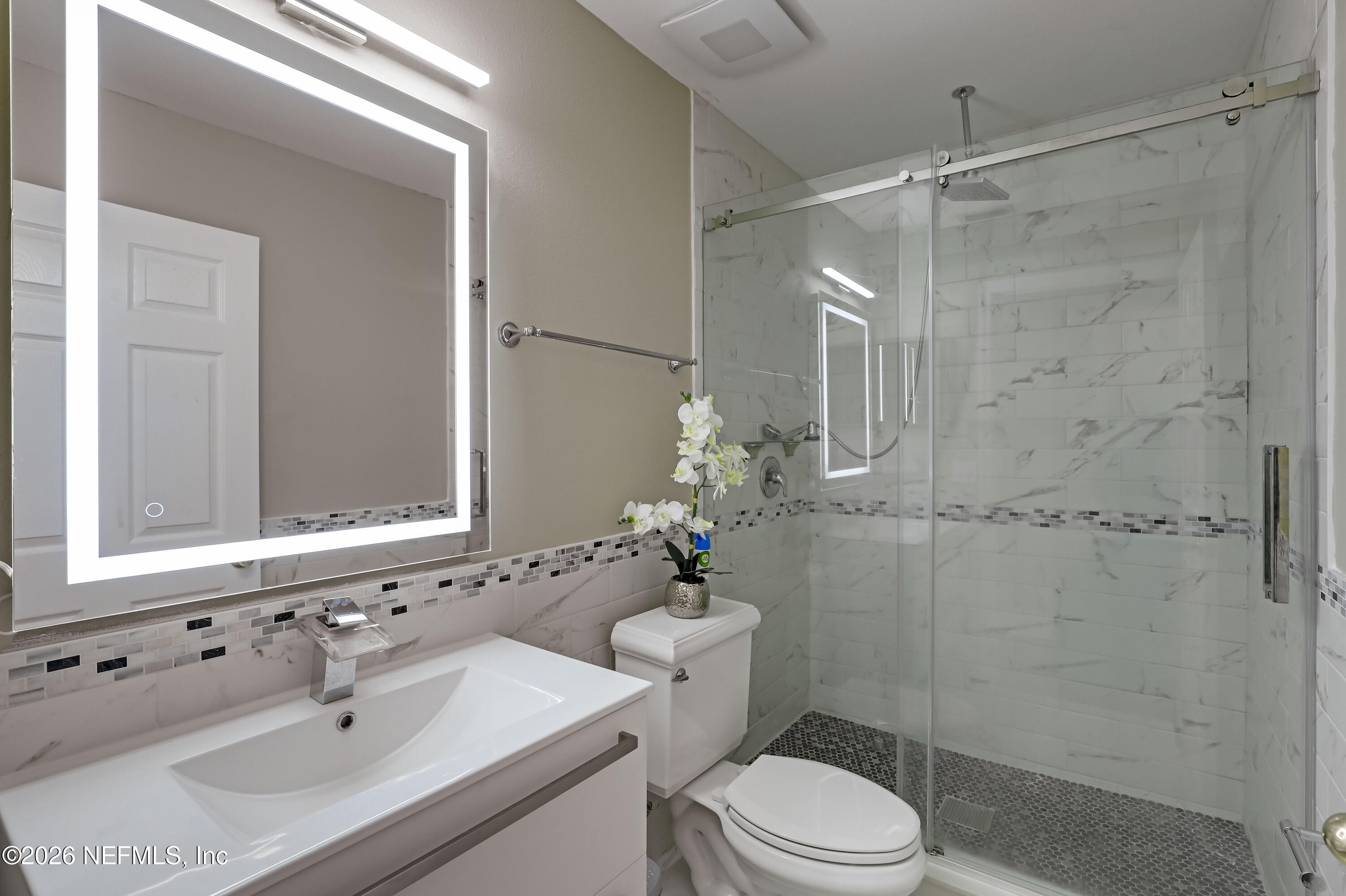 12559 Reeding Ridge Drive North Jacksonville, FL 32225 - Photo 12 of 42 a bathroom with a sink toilet a mirror and shower