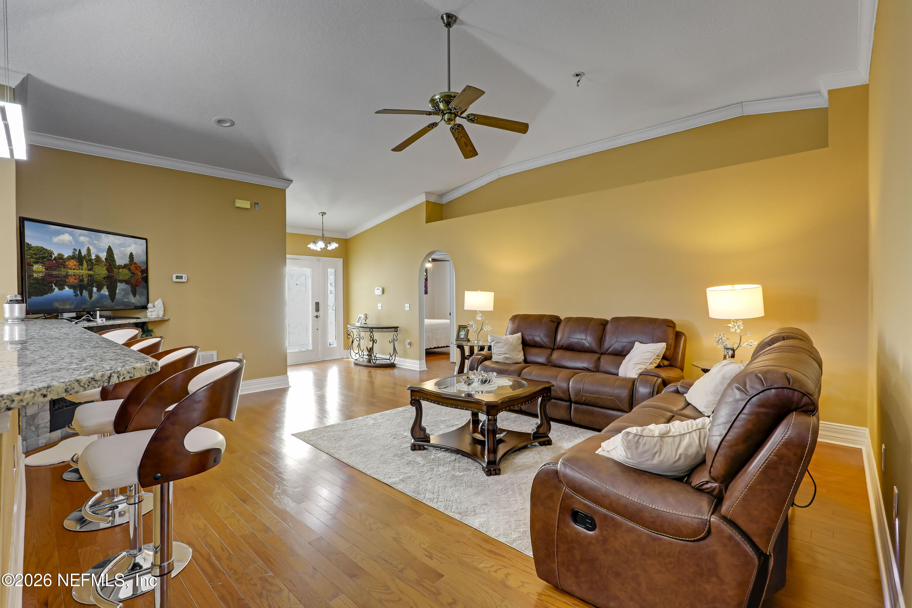 12559 Reeding Ridge Drive North Jacksonville, FL 32225 - Photo 16 of 42 a living room with couches and kitchen view with wooden floor
