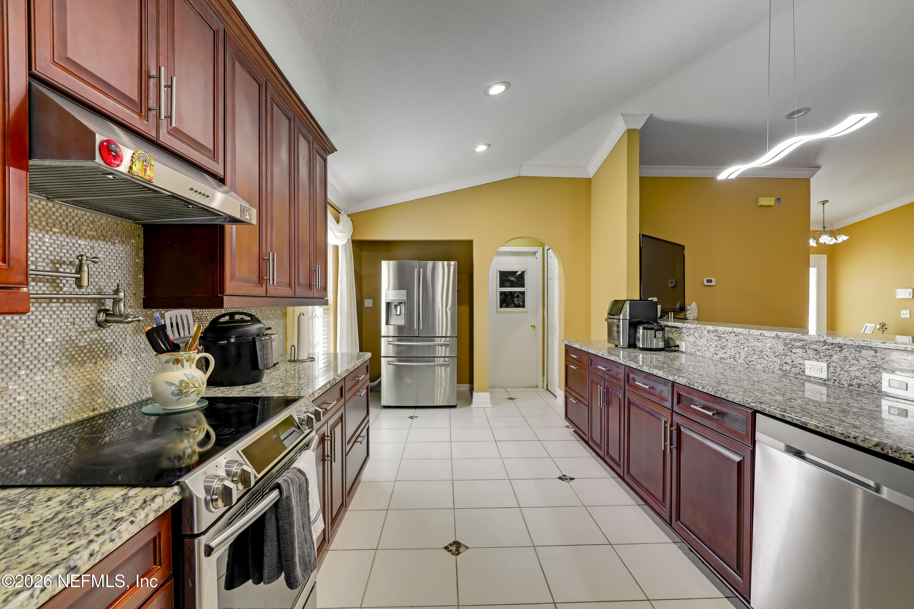 12559 Reeding Ridge Drive North Jacksonville, FL 32225 - Photo 21 of 42 a kitchen with stainless steel appliances granite countertop a sink counter space cabinets and a stove