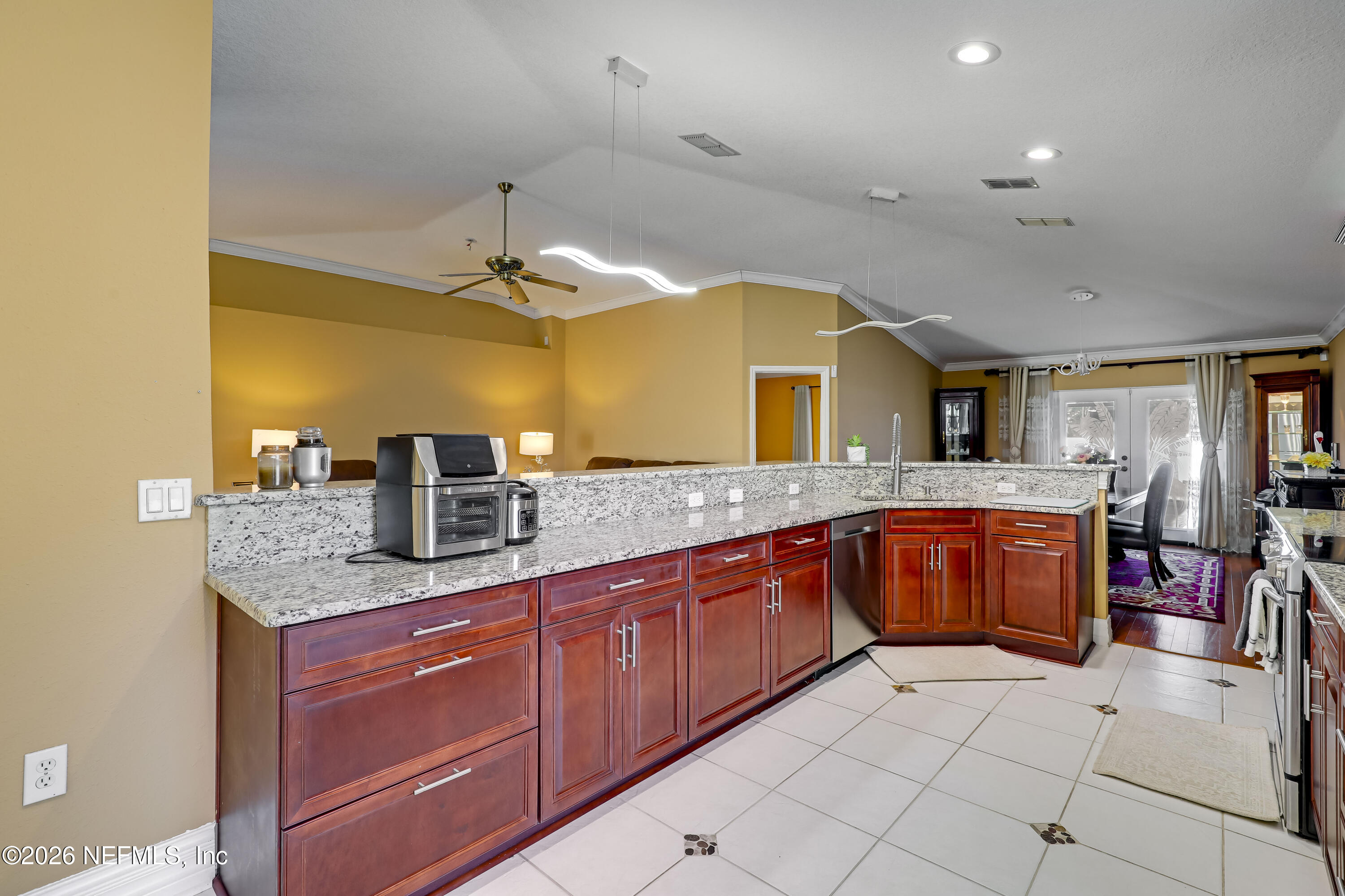12559 Reeding Ridge Drive North Jacksonville, FL 32225 - Photo 23 of 42 a large kitchen with stainless steel appliances granite countertop a sink and cabinets