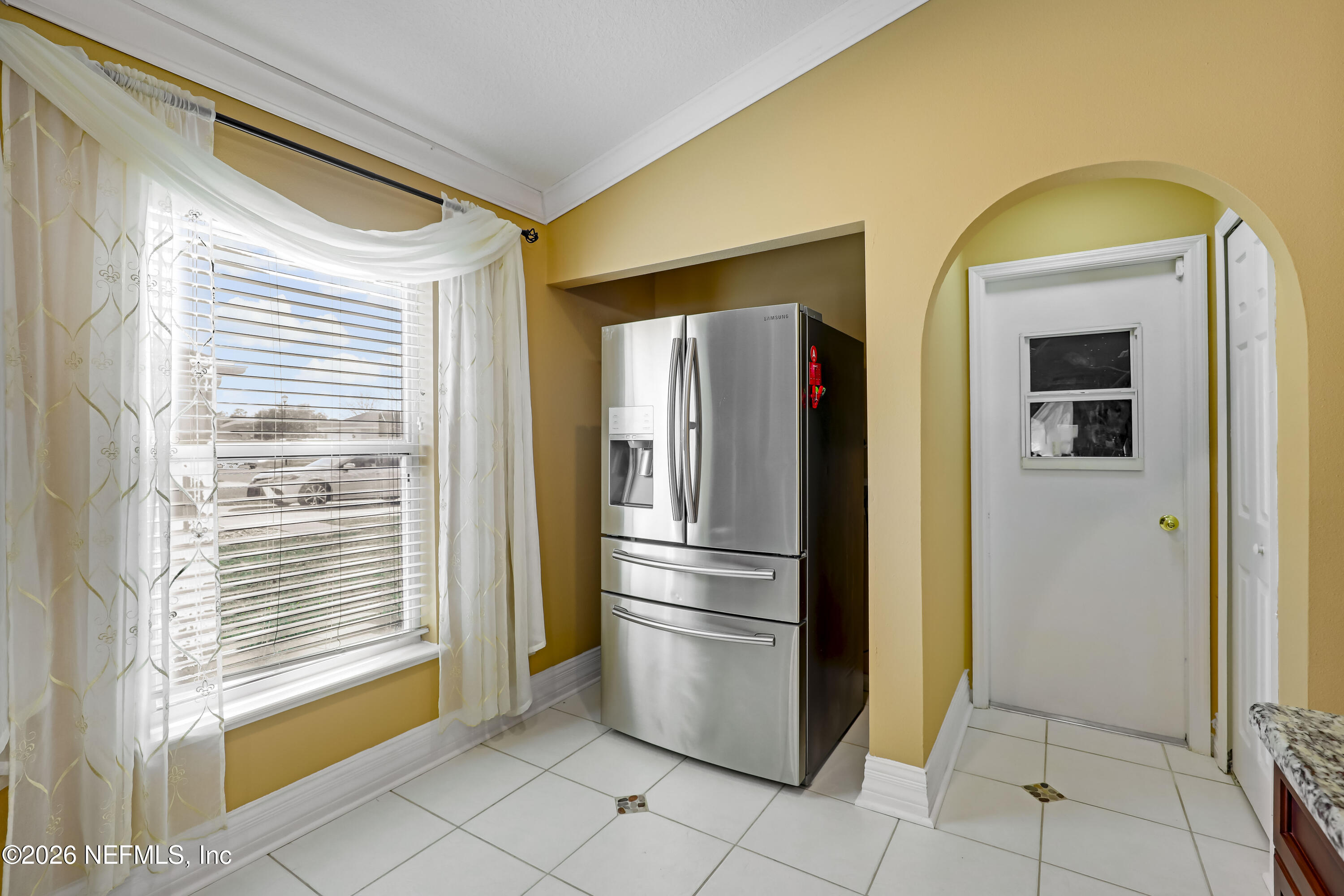 12559 Reeding Ridge Drive North Jacksonville, FL 32225 - Photo 24 of 42 a kitchen with windows and refrigerator