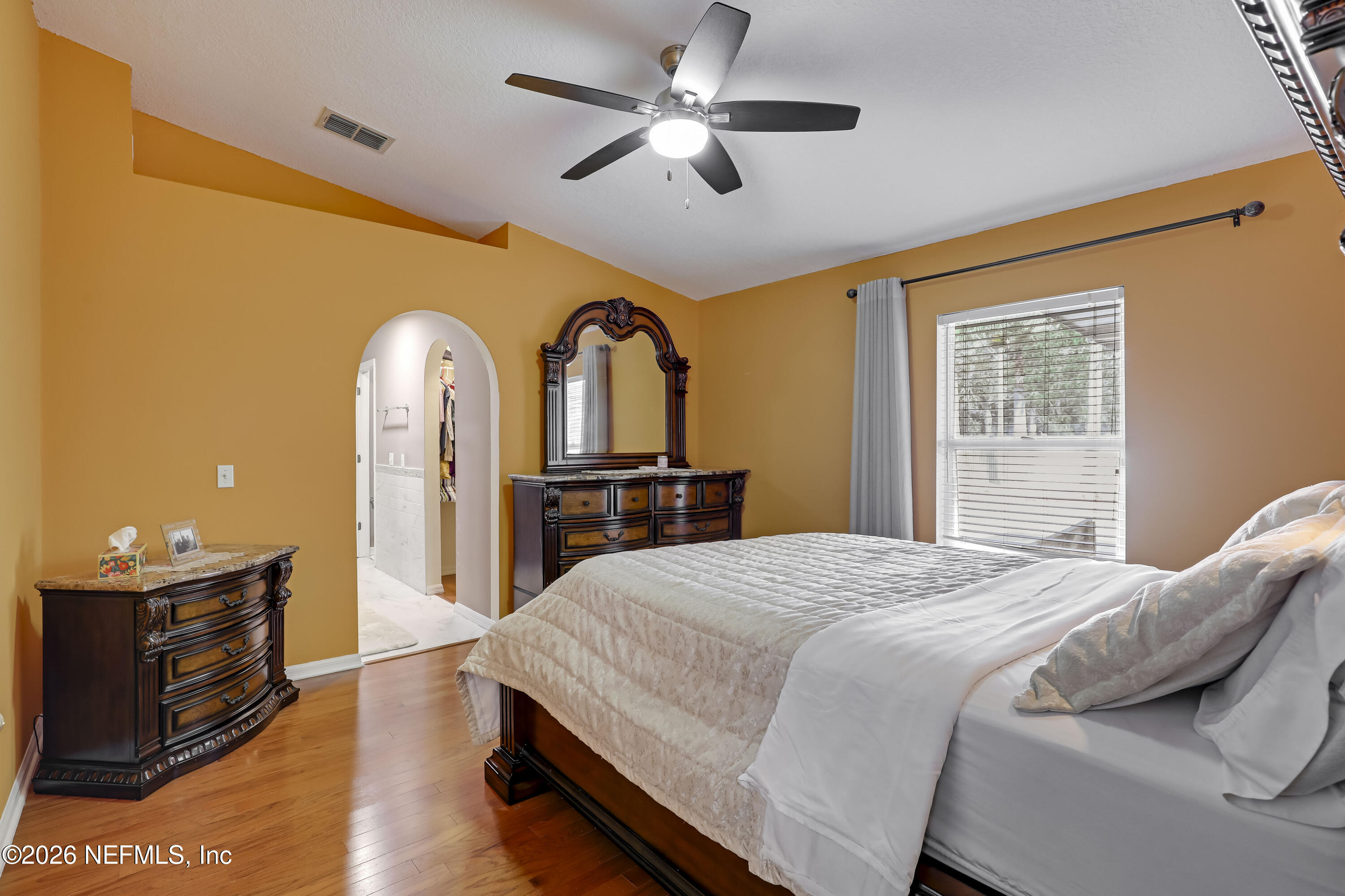 12559 Reeding Ridge Drive North Jacksonville, FL 32225 - Photo 28 of 42 a bedroom with a bed and a dresser with wooden floor
