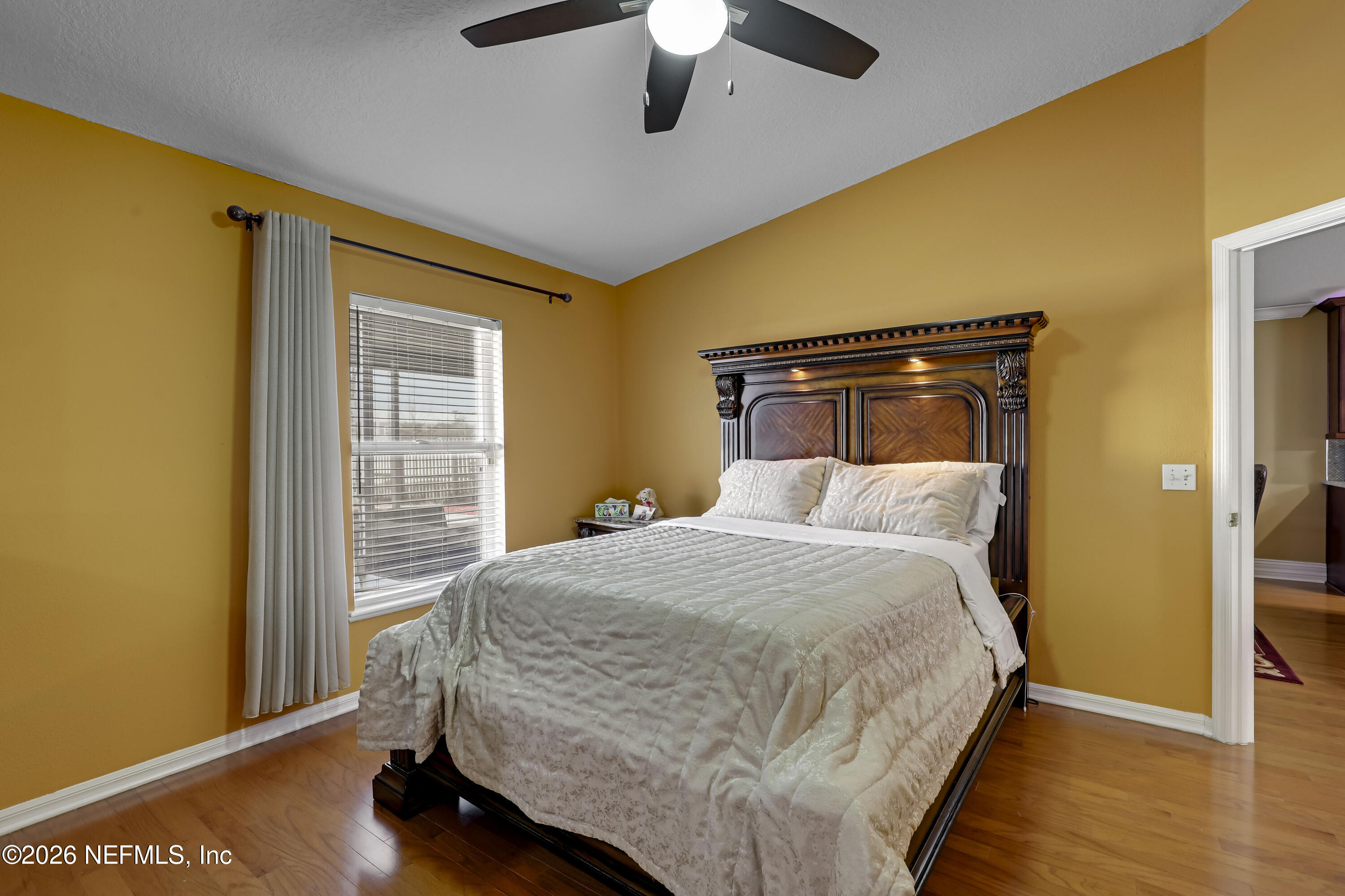 12559 Reeding Ridge Drive North Jacksonville, FL 32225 - Photo 29 of 42 a bedroom with a bed and wooden floor