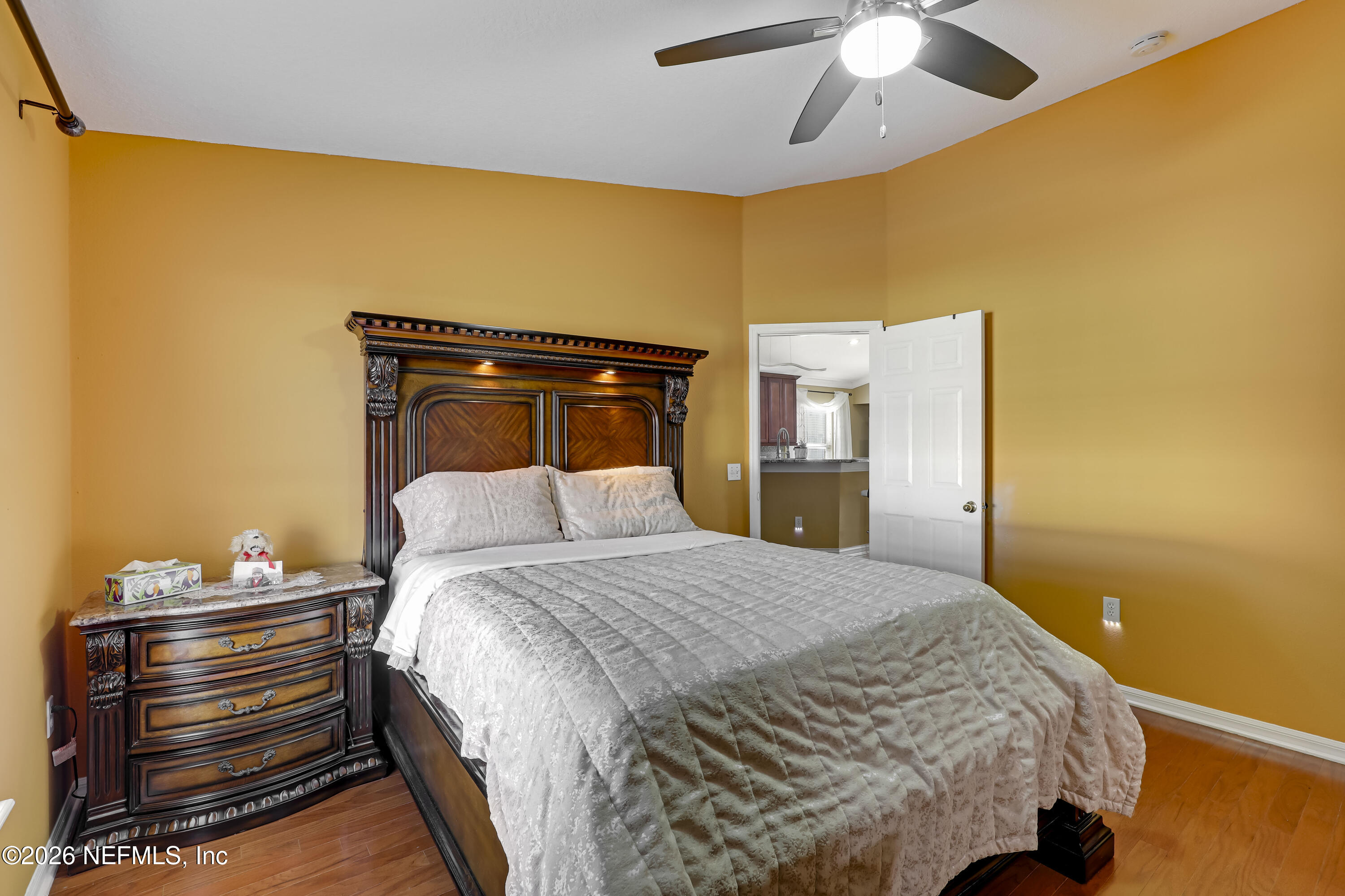 12559 Reeding Ridge Drive North Jacksonville, FL 32225 - Photo 30 of 42 a bedroom with a bed and a chandelier