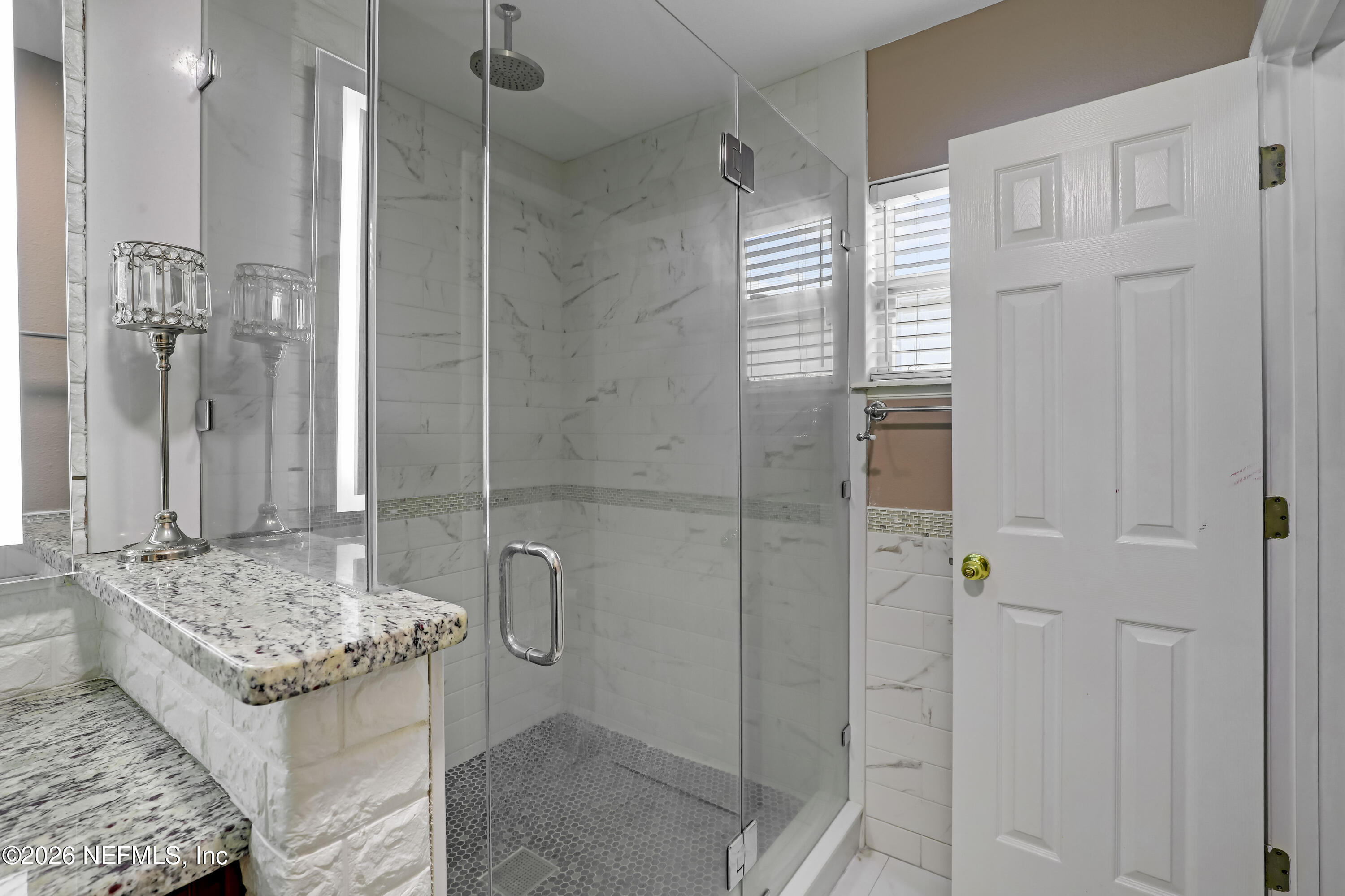 12559 Reeding Ridge Drive North Jacksonville, FL 32225 - Photo 33 of 42 a bathroom with a granite countertop sink and shower