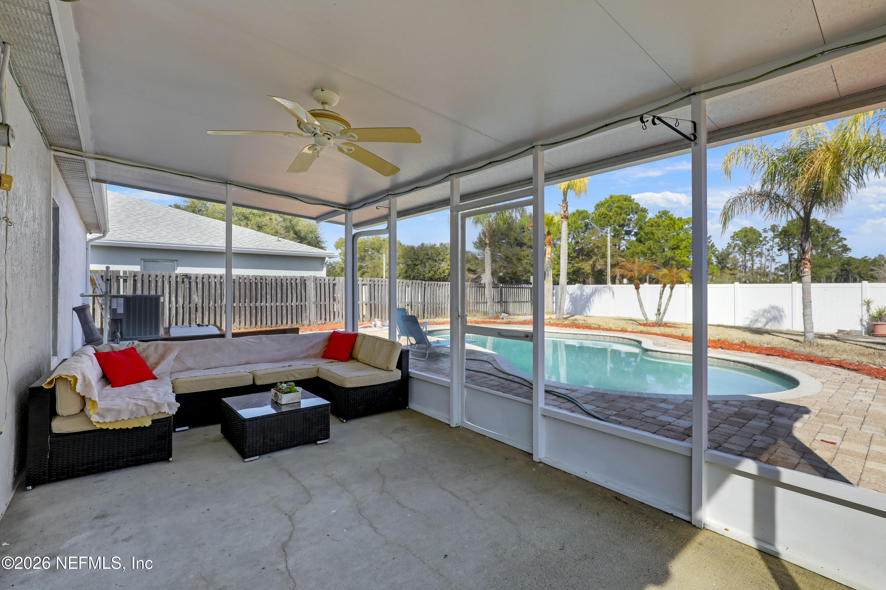 12559 Reeding Ridge Drive North Jacksonville, FL 32225 - Photo 35 of 42 a living room with couch and floor to ceiling window