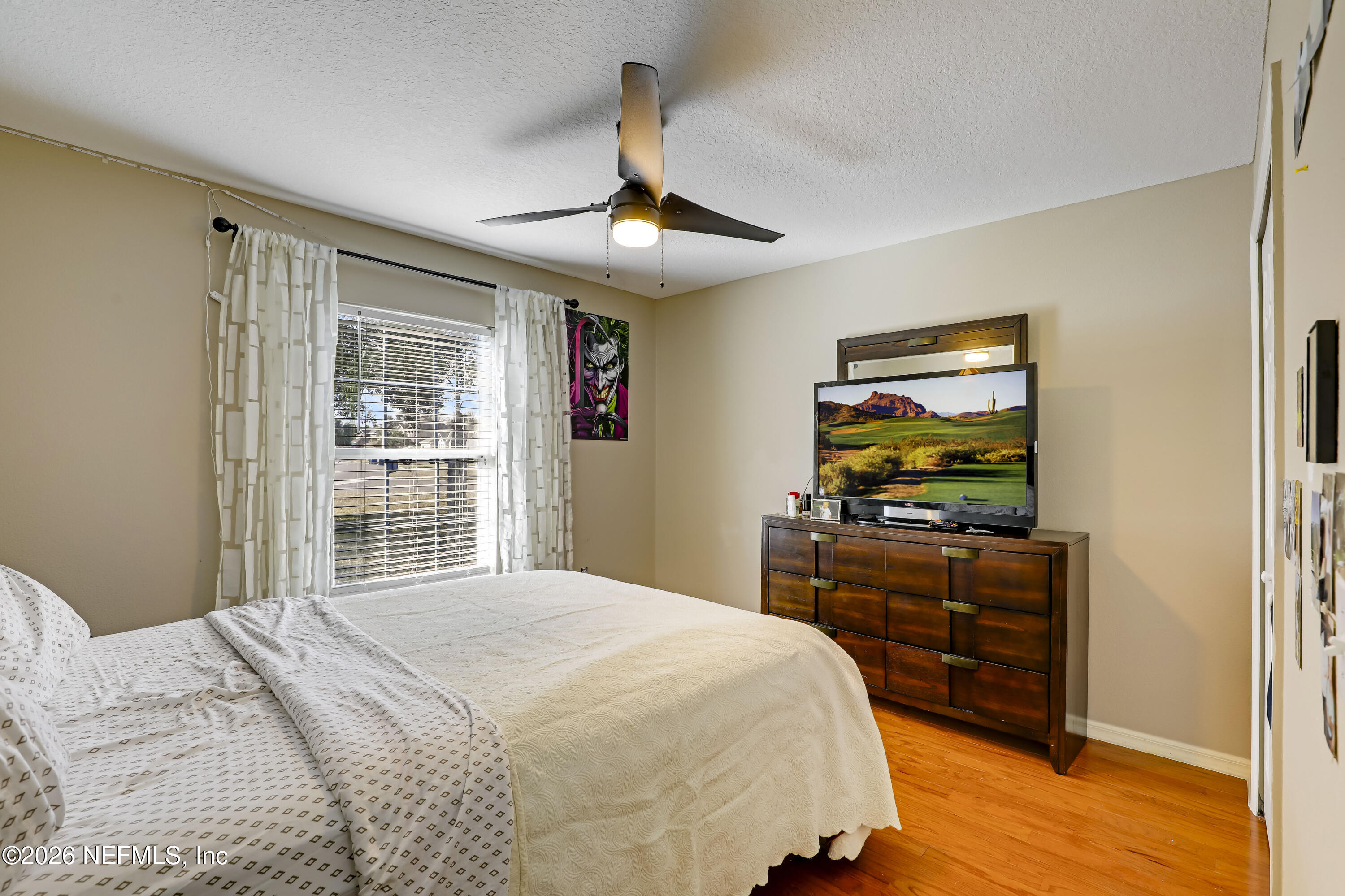 12559 Reeding Ridge Drive North Jacksonville, FL 32225 - Photo 9 of 42 a bedroom with a bed and a flat screen tv