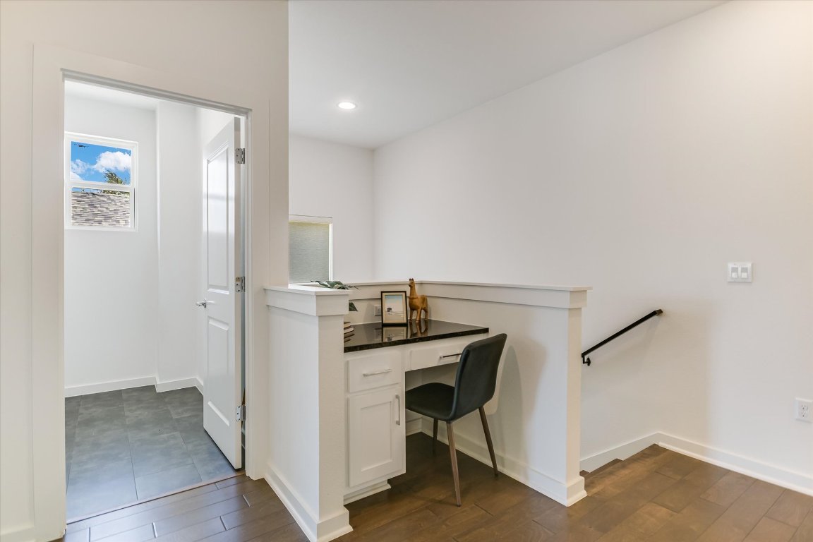 1916 Bunche Road Austin, TX 78721 - Photo 12 of 22 a view of a hallway with workspace and wooden floor