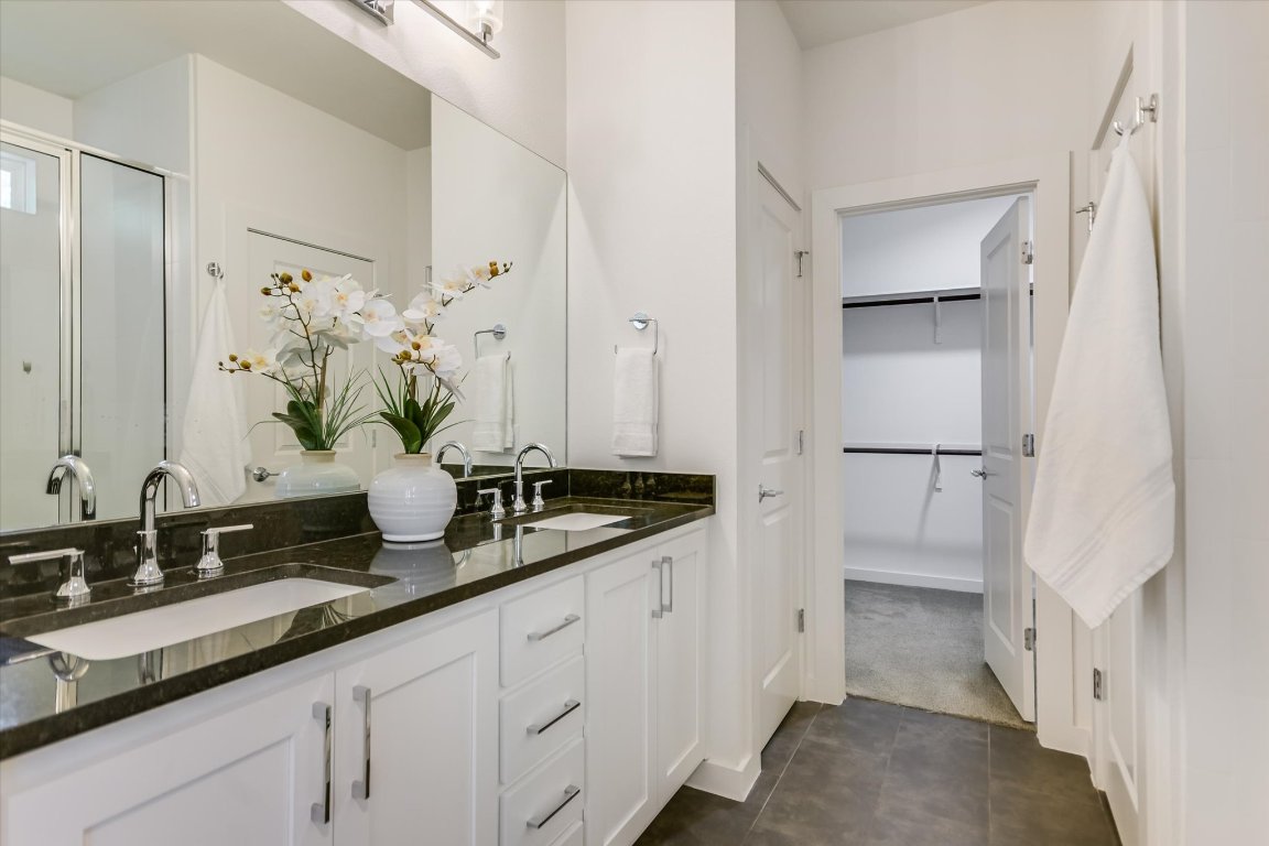 1916 Bunche Road Austin, TX 78721 - Photo 15 of 22 a bathroom with a granite countertop sink and a mirror