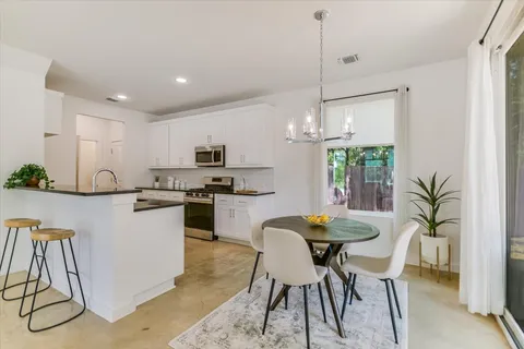 a kitchen with white cabinets and white appliances