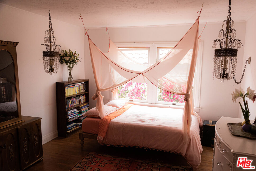 1515 Murray Circle Los Angeles, CA 90026 - Photo 28 of 40 a bedroom with a bed a flat screen tv and a large window