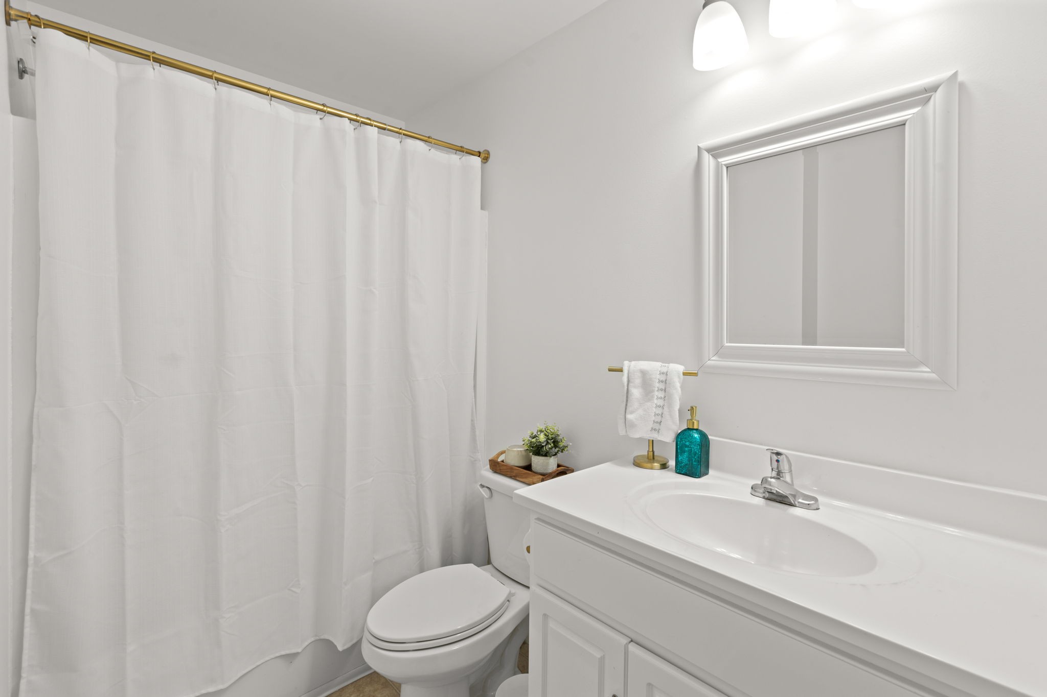 337 Duke Street Nashville, TN 37207 - Photo 8 of 28 a bathroom with a sink a toilet and shower curtain