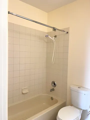 a spacious bathroom with a bathtub and shower