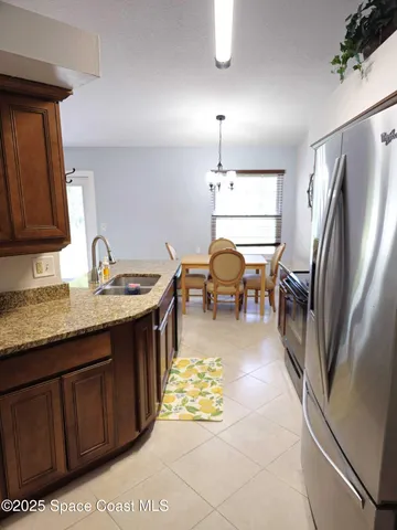 a kitchen with a refrigerator and a sink