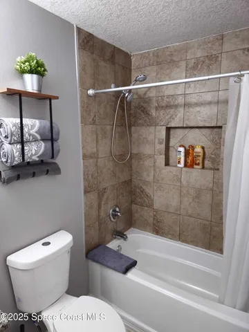 a bathroom with a toilet and shower