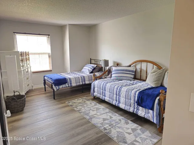 a spacious bedroom with two beds and a window