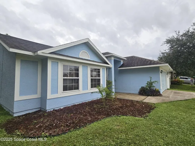 front view of a house with a yard