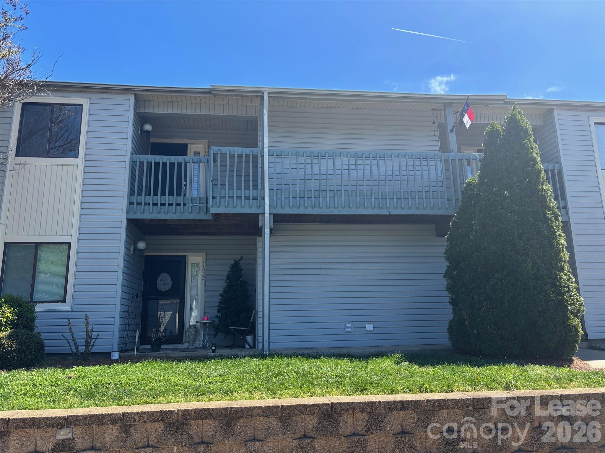 a view of a brick house with a yard
