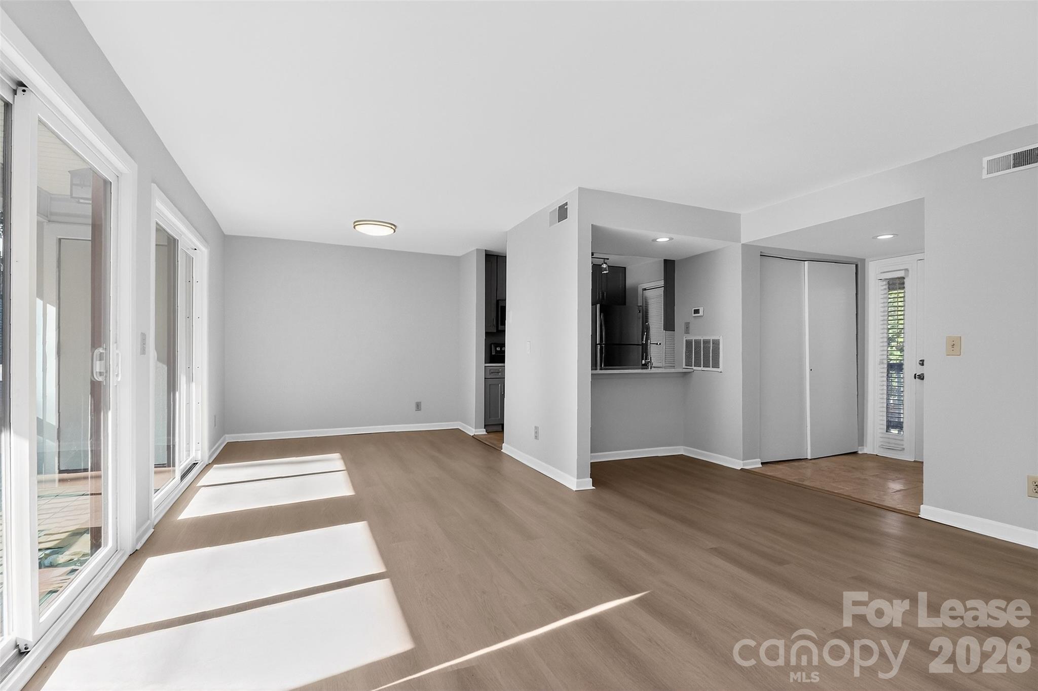 11029 Harrowfield Road Charlotte, NC 28226 - Photo 11 of 41 a view of an empty room with wooden floor and a window