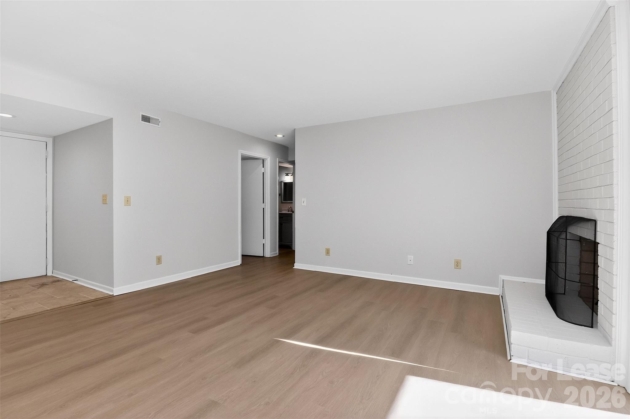 11029 Harrowfield Road Charlotte, NC 28226 - Photo 12 of 41 a view of an empty room with wooden floor