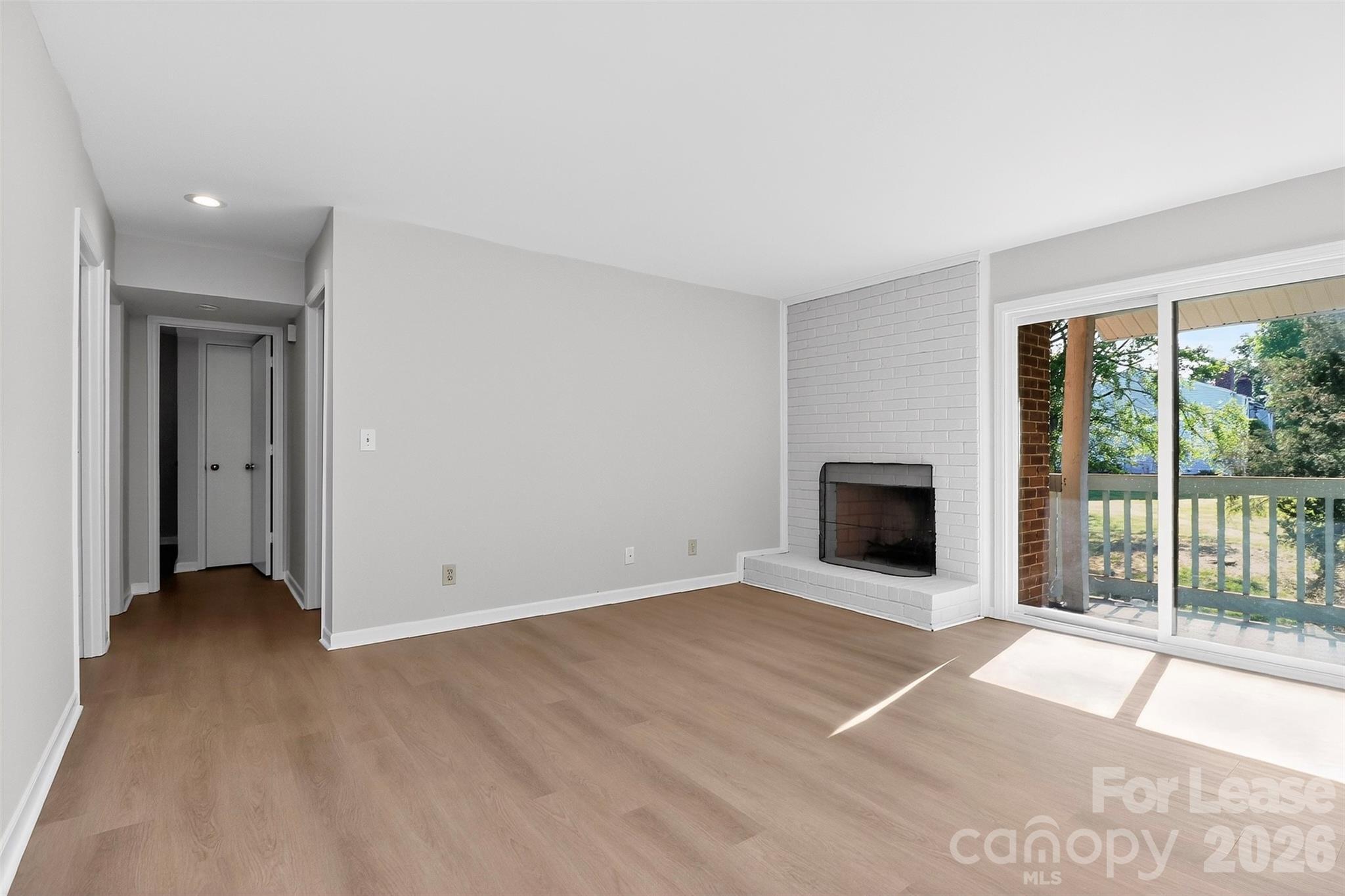 11029 Harrowfield Road Charlotte, NC 28226 - Photo 13 of 41 a view of an empty room with a fireplace and a window