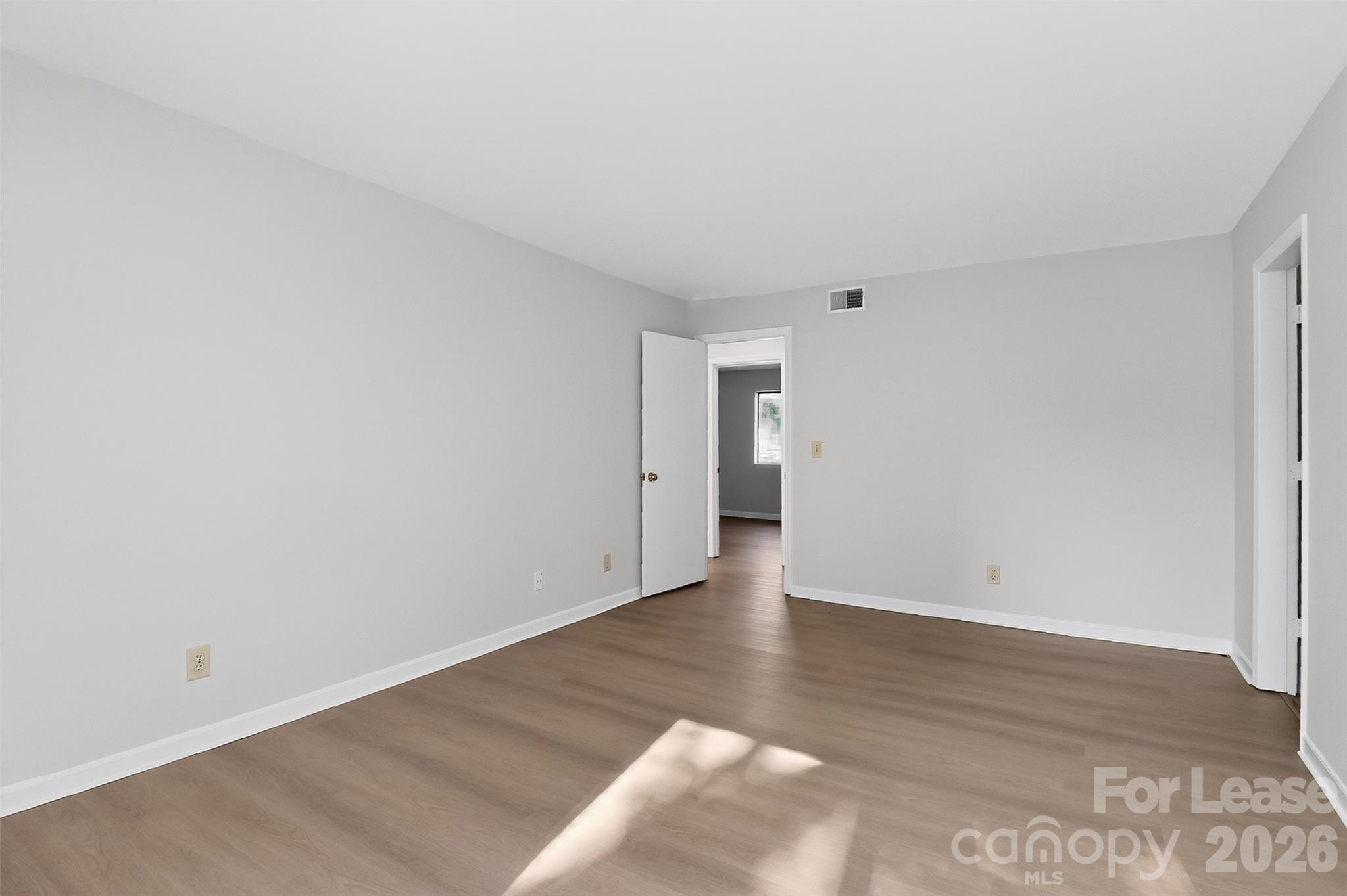 11029 Harrowfield Road Charlotte, NC 28226 - Photo 19 of 41 a view of an empty room with wooden floor