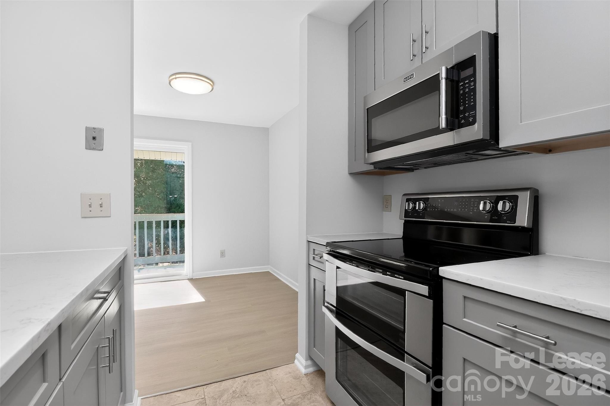11029 Harrowfield Road Charlotte, NC 28226 - Photo 2 of 41 a kitchen with microwave cabinets and stainless steel appliances