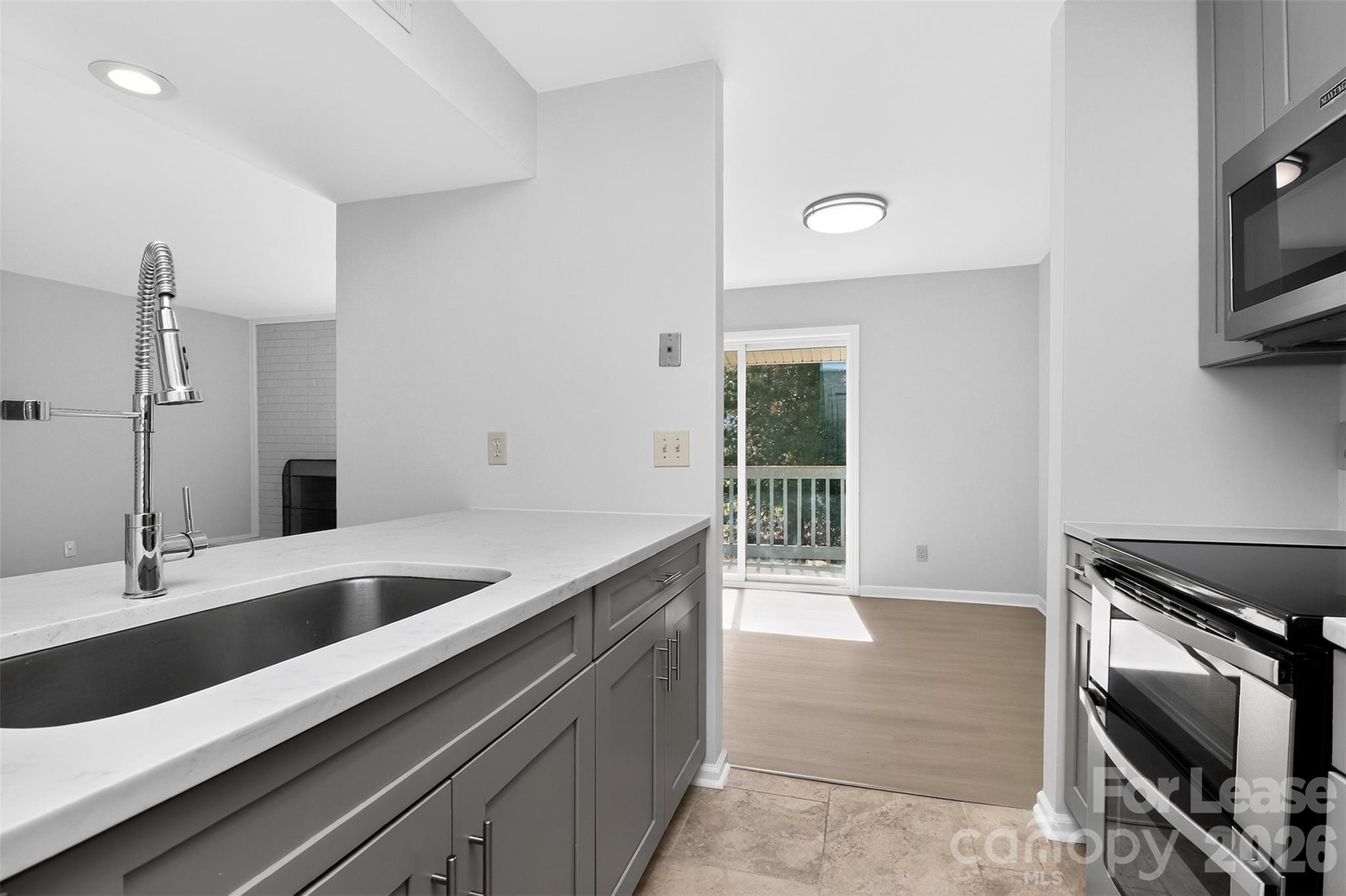 11029 Harrowfield Road Charlotte, NC 28226 - Photo 6 of 41 a kitchen with a sink and stainless steel appliances