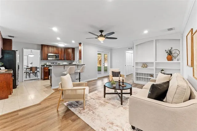 a living room with furniture and kitchen view