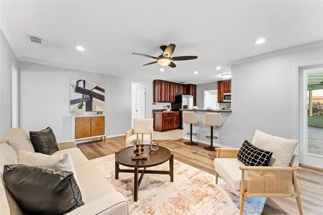 a living room with furniture and kitchen view