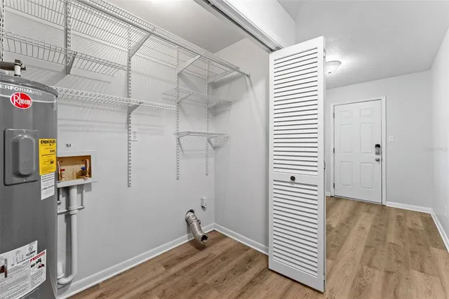 a view of a room with wooden floor and bathroom
