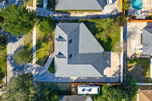an aerial view of a house with a yard