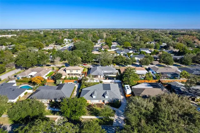 an aerial view of a houses with a yard