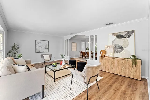 a living room with furniture and wooden floor