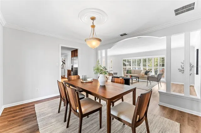 a view of a dining room with furniture and wooden floor