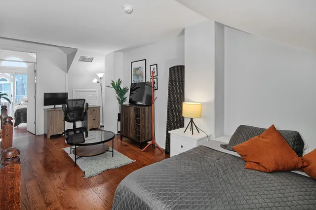 a bedroom with furniture and a lamp