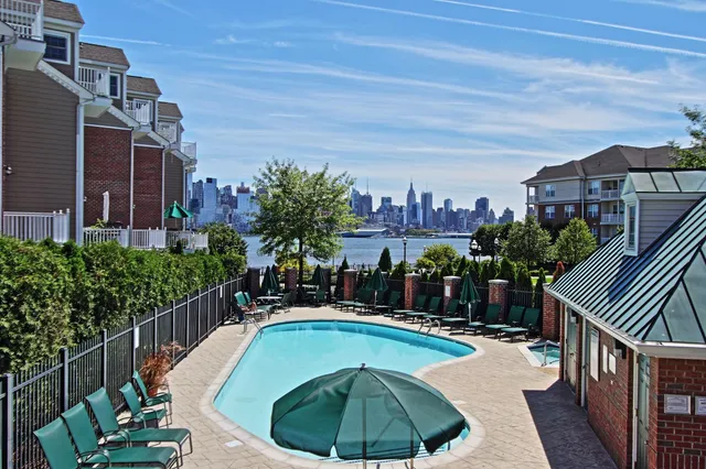 a swimming pool with outdoor seating and yard