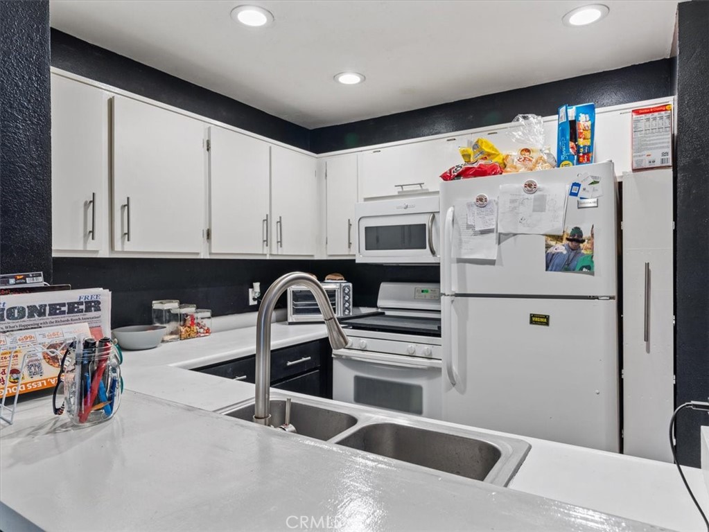 2403 Country Santa Maria, CA 93455 - Photo 12 of 29 a kitchen with a refrigerator and white cabinets