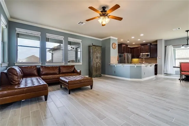 a living room with furniture and kitchen view