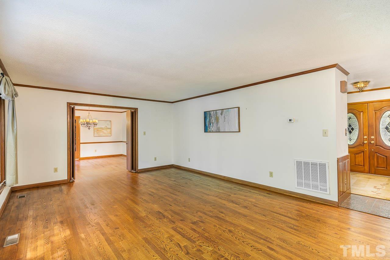8600 Lawn Court Raleigh, NC 27613 - Photo 11 of 31 a view of an empty room with wooden floor and a window