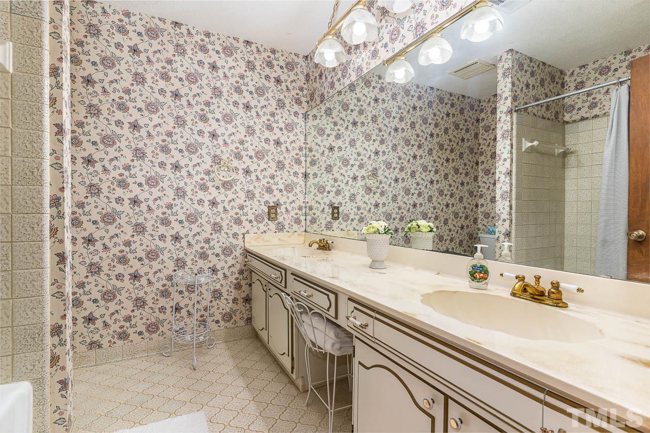 8600 Lawn Court Raleigh, NC 27613 - Photo 19 of 31 a bathroom with a sink mirror and shower