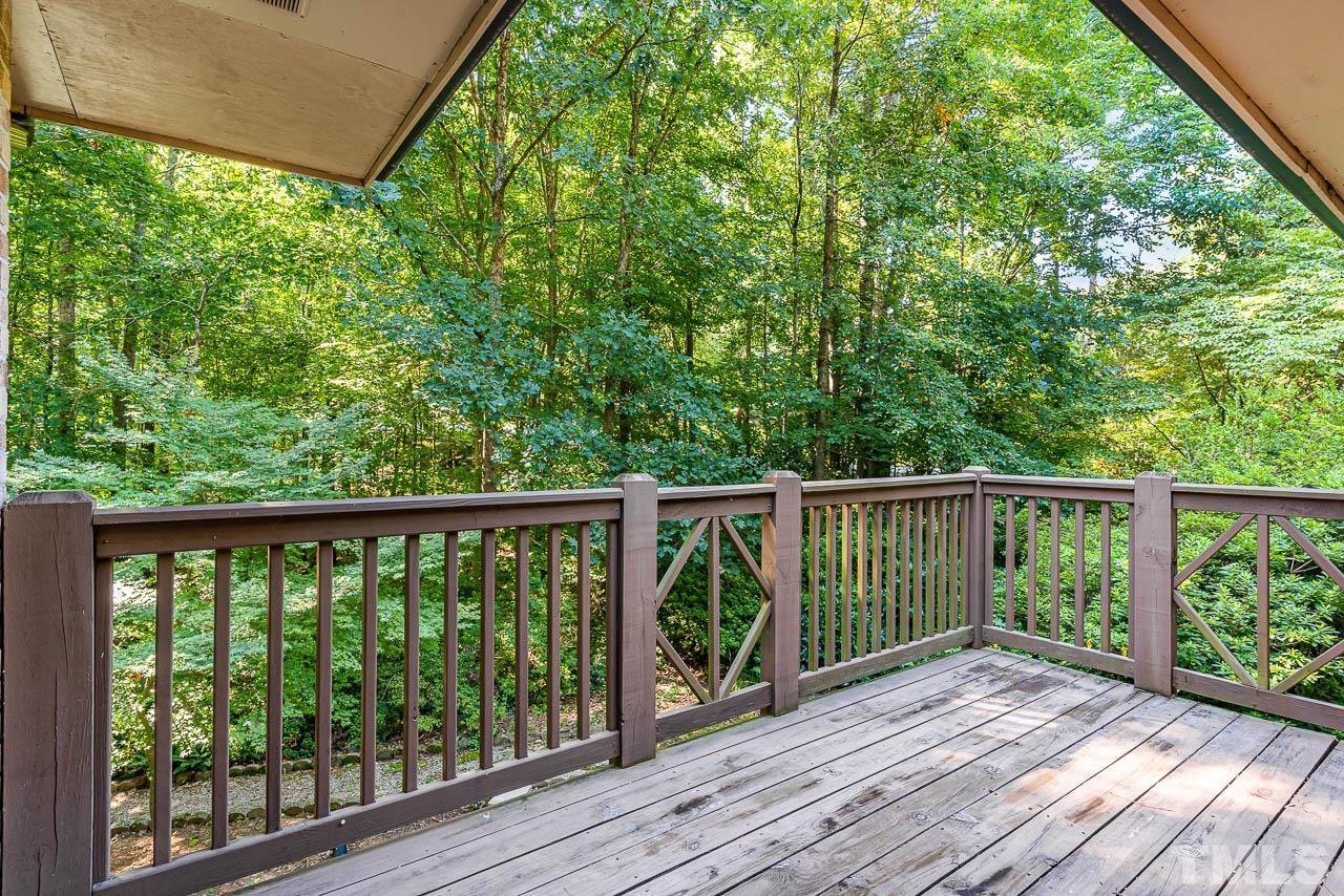 8600 Lawn Court Raleigh, NC 27613 - Photo 2 of 31 a view of balcony with wooden floor and fence
