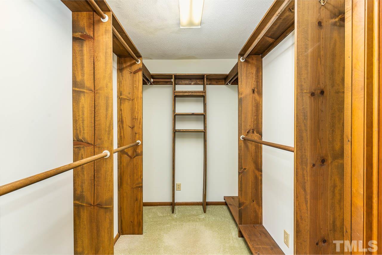 8600 Lawn Court Raleigh, NC 27613 - Photo 21 of 31 a view of walk in closet with empty racks