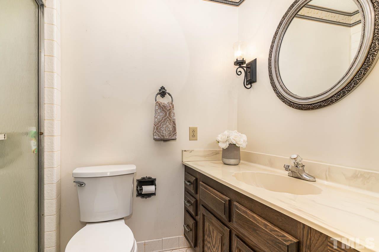 8600 Lawn Court Raleigh, NC 27613 - Photo 22 of 31 a bathroom with a sink and a mirror