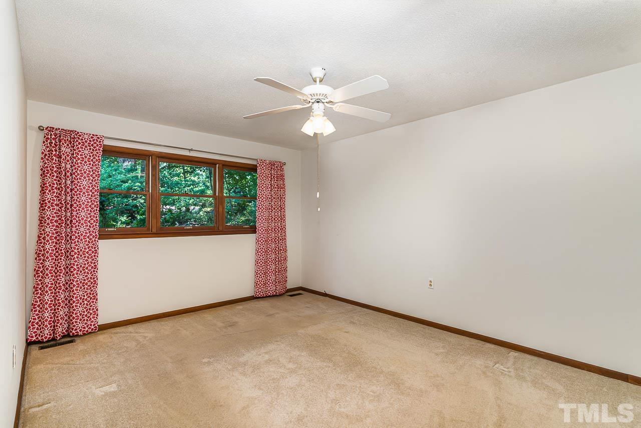 8600 Lawn Court Raleigh, NC 27613 - Photo 26 of 31 an empty room with a window and a fan